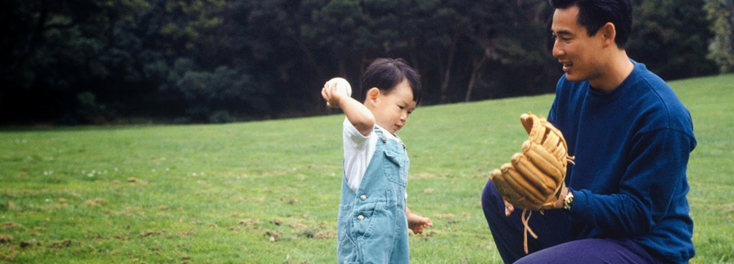 Image of father with toddler playing ball