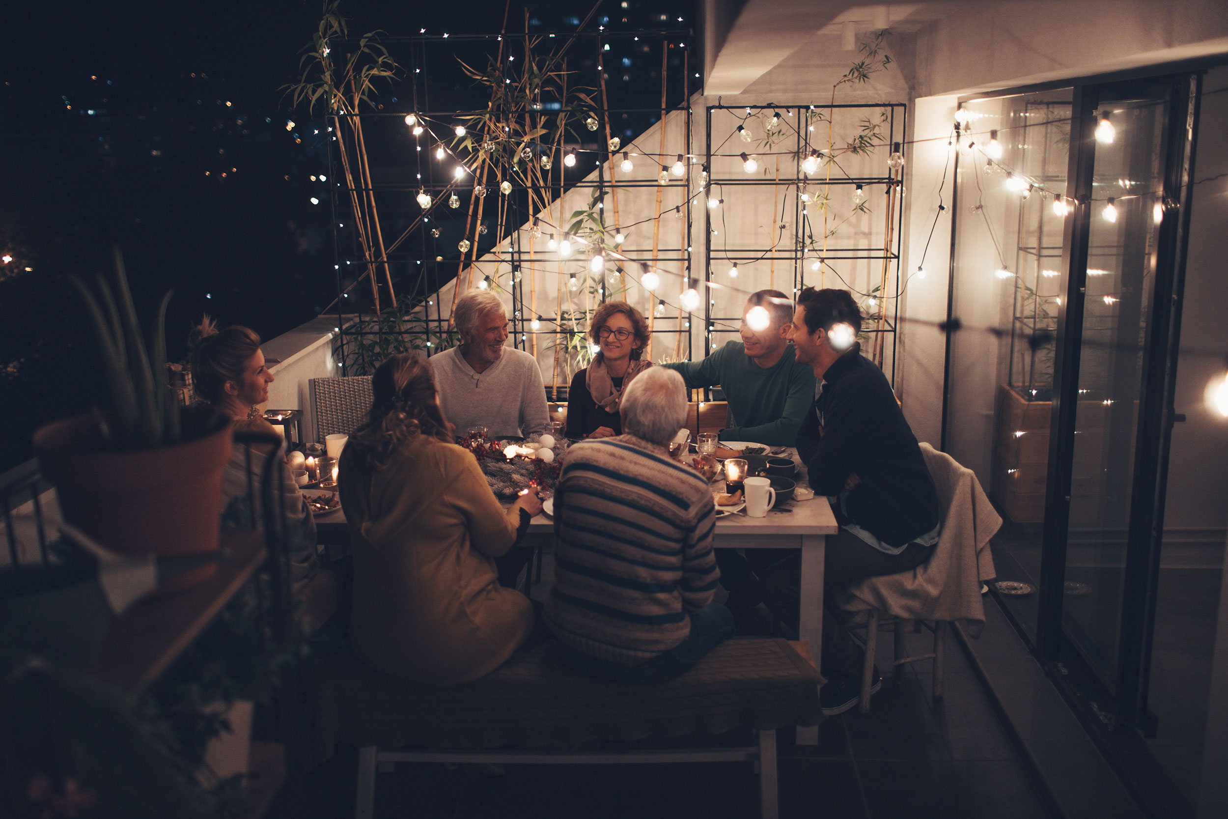 Photo of a family around the dinner table for Passover, shown laughing and enjoying each other's company.
