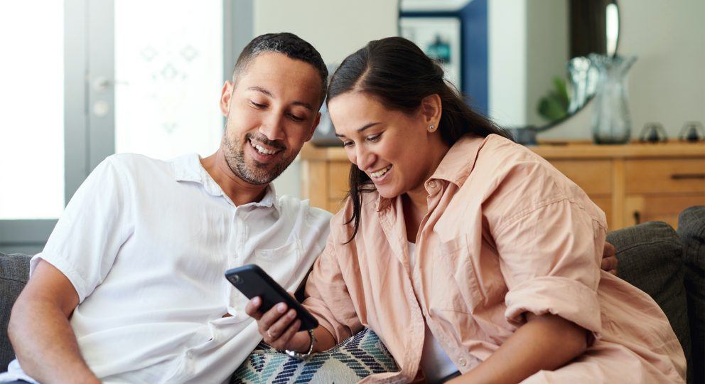 Couple looking at phone Gottman Marriage Minute Email Newsletter