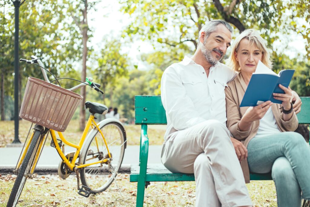Senior couple reading in the park