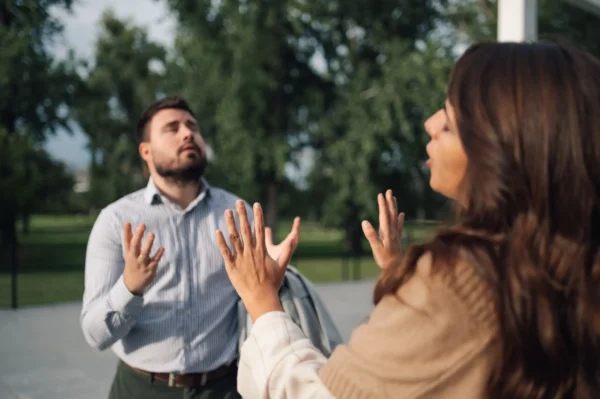Couple arguing with one partner showing defensiveness.