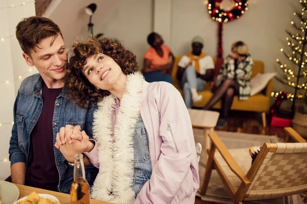 Young couple in a loving moment while at a holiday party.
