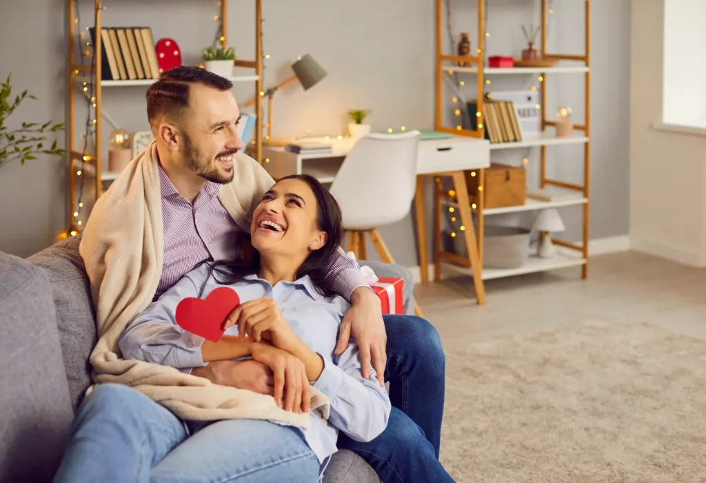 A couple together at home celebrating Valentine's Day.