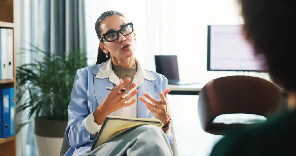 A female therapist is working with a client in session.