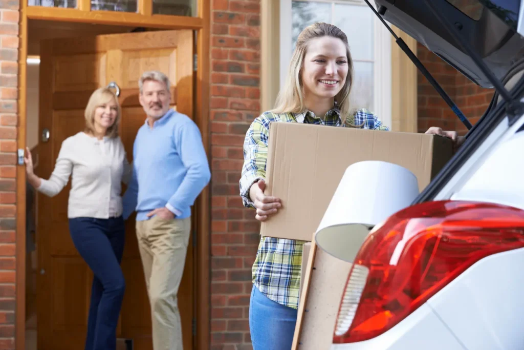 A couple saying goodbye as their adult daughter moves out.